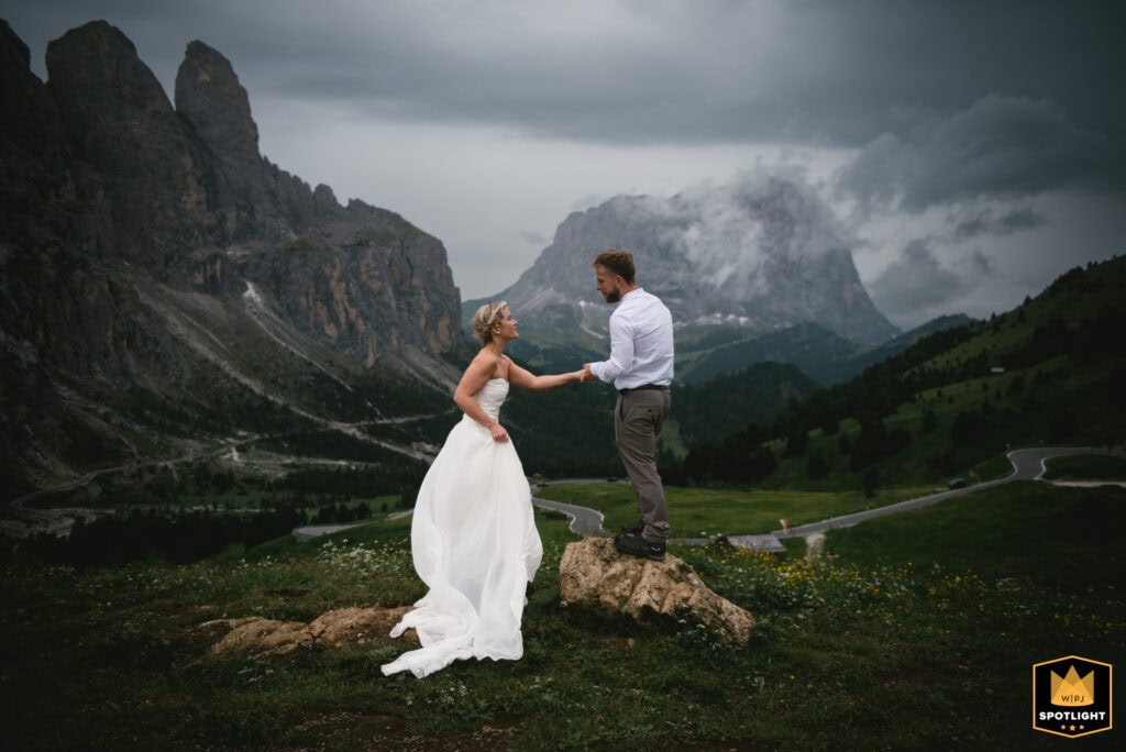 Elopement couple exchanging vows in dramatic mountain scenery in Italy.