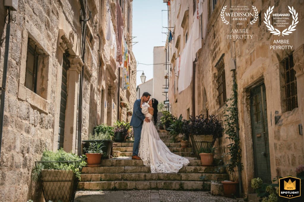 Elopement couple kissing on historic Italian stairs, romantic wedding scene in Italy.