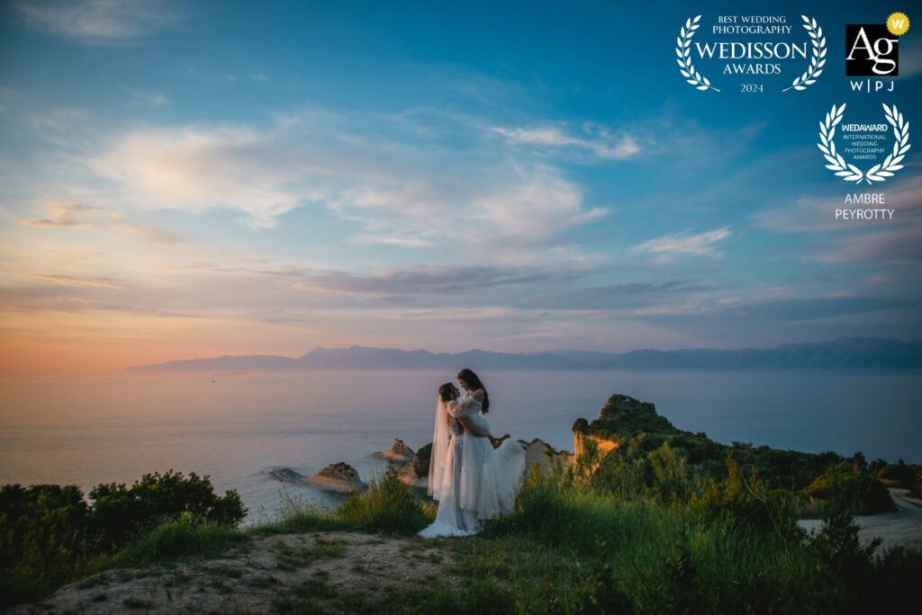 Elopement wedding at sunset with ocean view in Italy, featuring a bride and groom embracing on a scenic coast.