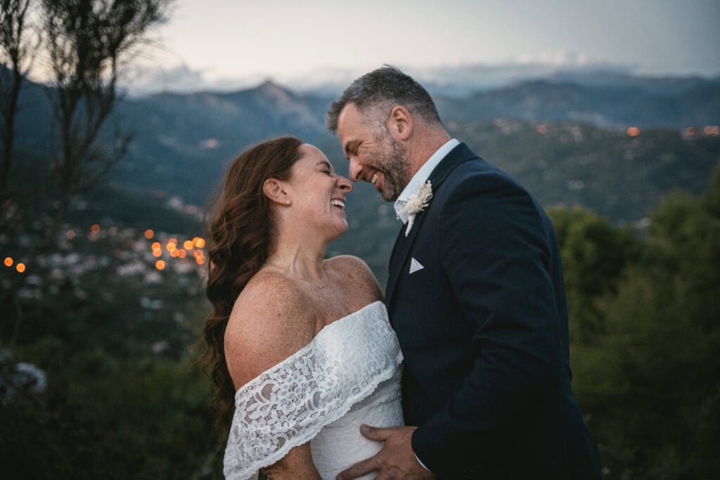 Romantic couple celebrating their elopement outdoors in Italy with scenic mountain views.