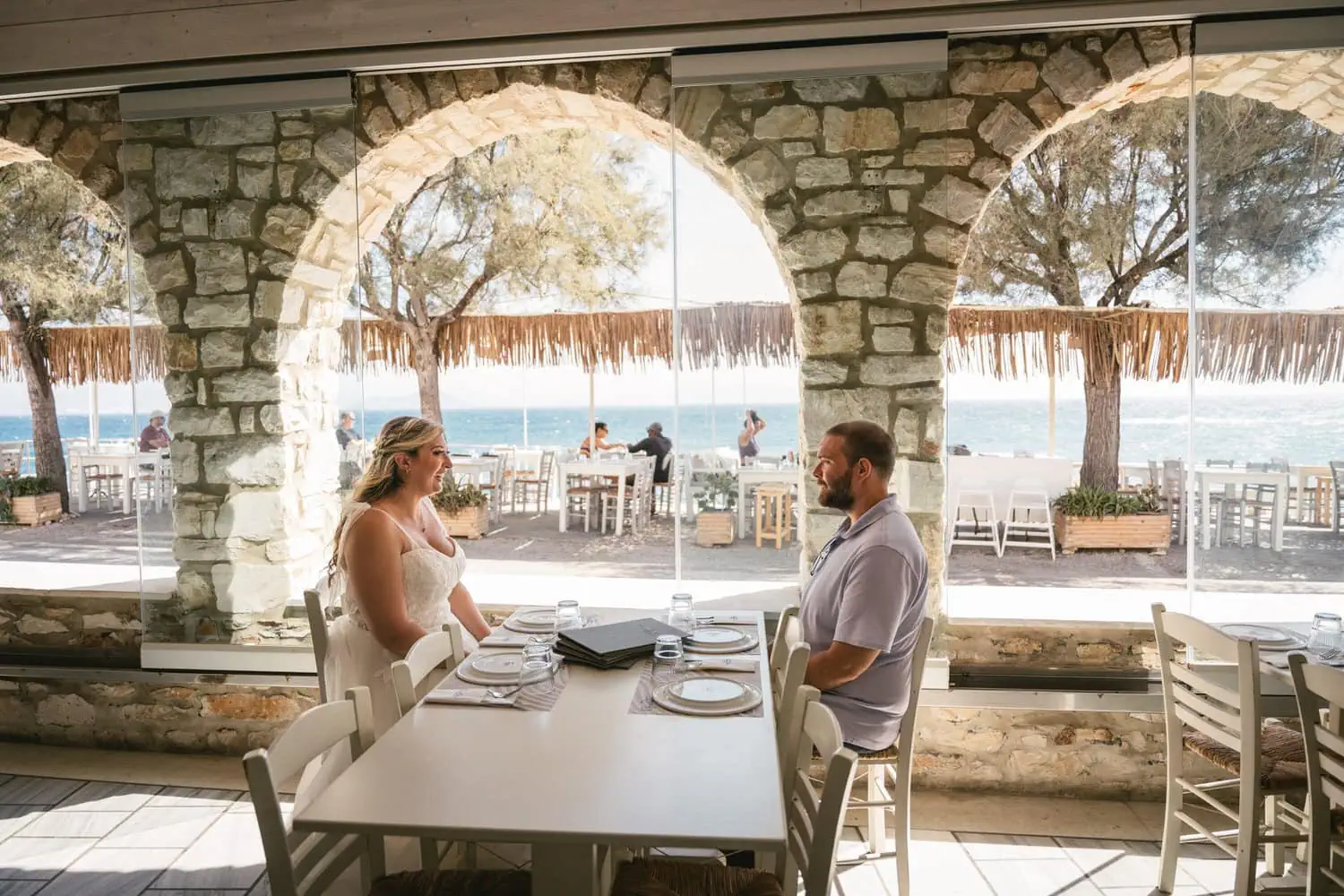 Elopement ceremony during sunset at a seaside restaurant on Paros, Greece.