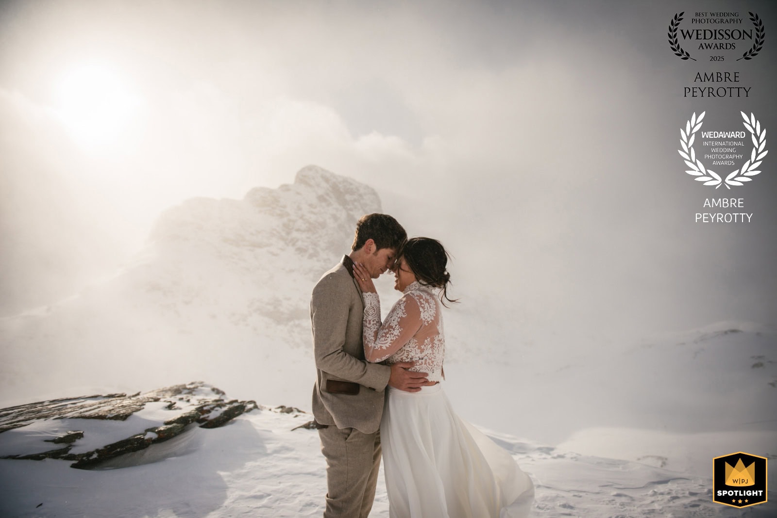 Elopement couple embracing in snowy Swiss mountain landscape during a romantic wedding shoot.