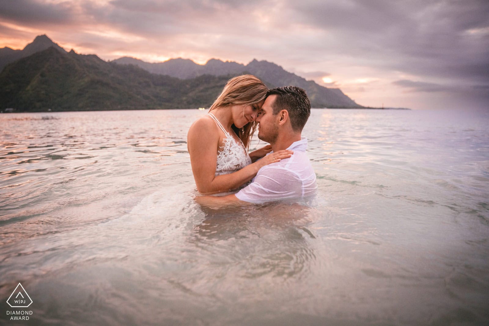 Bride and groom exchanging vows alone on a private Fiji beach with turquoise lagoon behind them